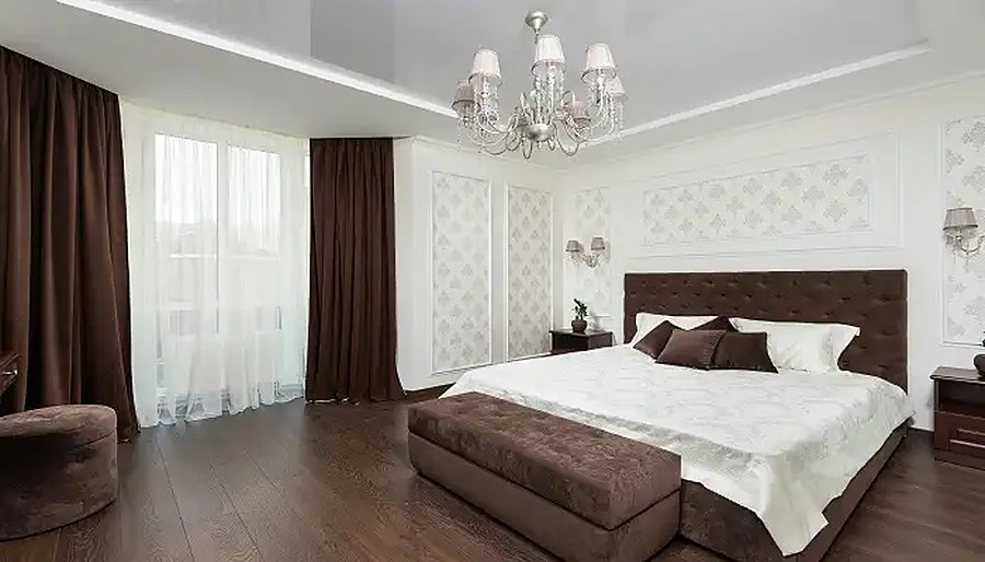 Garden view suite room with chandelier and king bed at Myra Golden Beach Resort