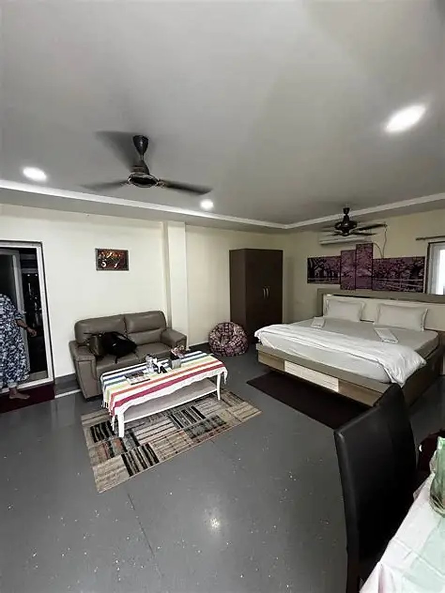 Upstairs room with king bed and seating area at Myra Golden Beach Resort